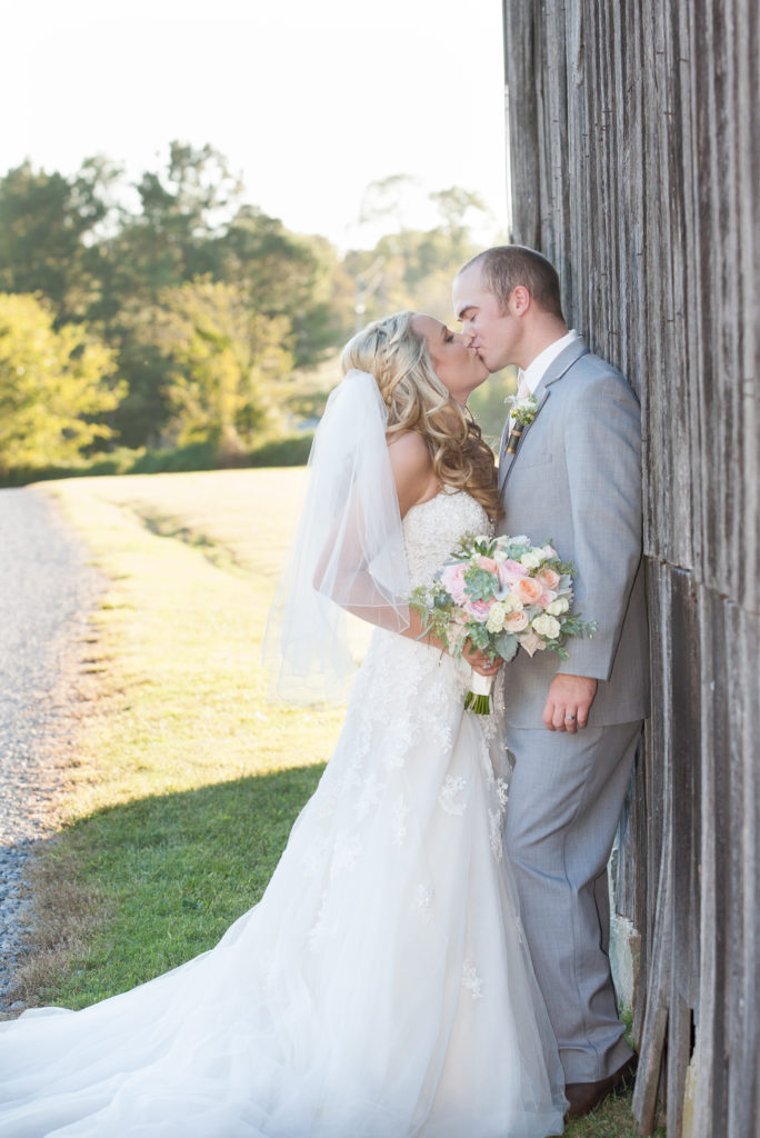 farm wedding kiss at barn