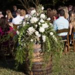 outdoor wedding flowers on whiskey barrel